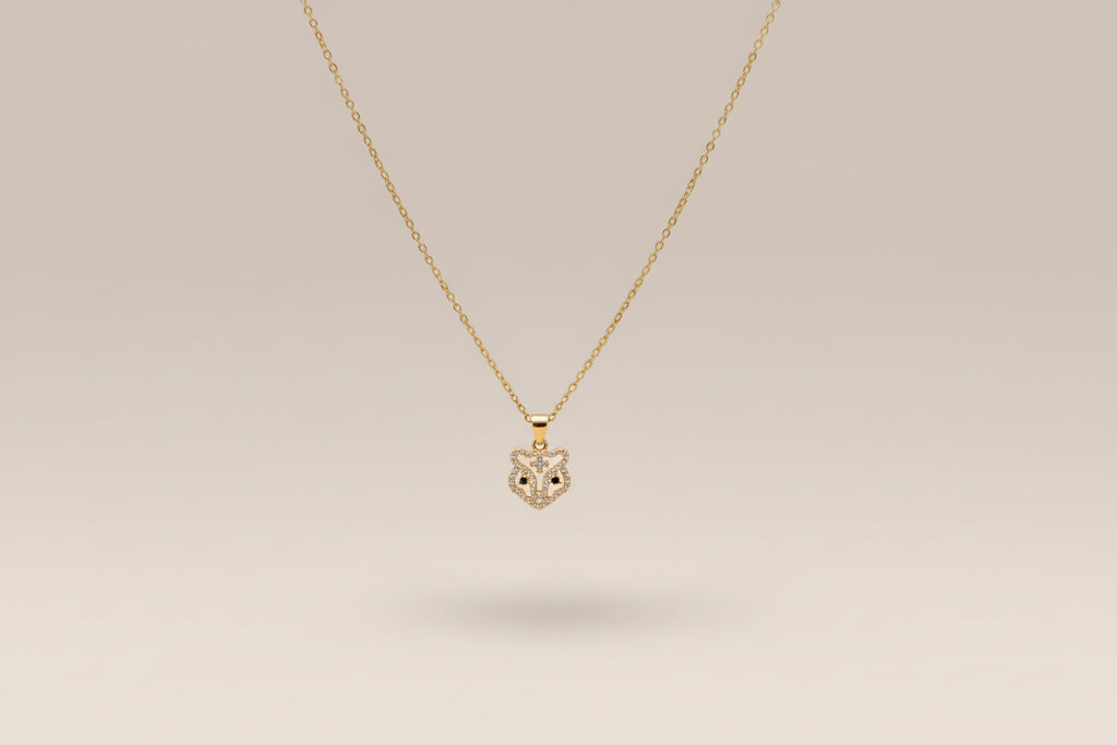 Stainless steel gold necklace with a tb pendant