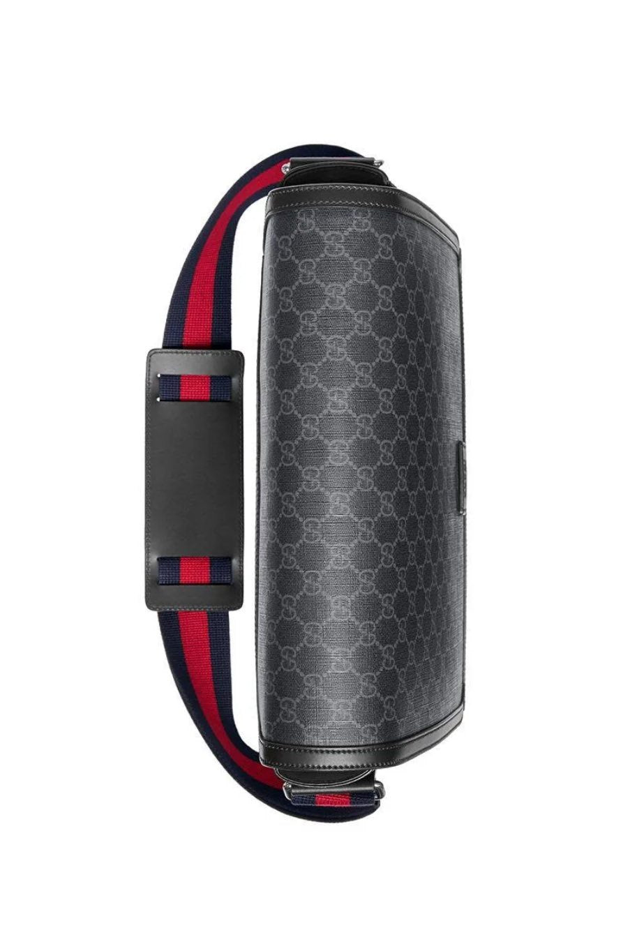 Black patterned shoulder bag with red and blue straps