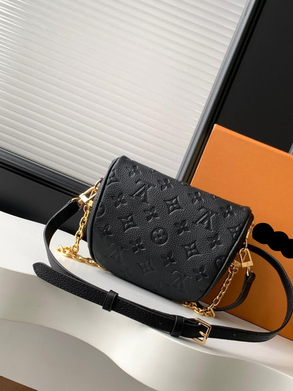 Black handbag with gold chain strap 