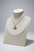 Silver necklace with a saturn/safety pin pendant