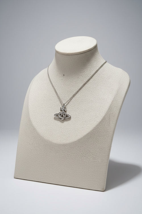 Silver necklace with a saturn/safety pin pendant