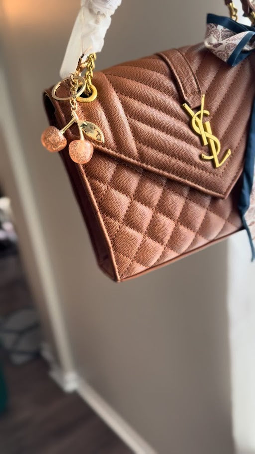 Brown quilted handbag with a gold chain 