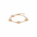 Gold floral bracelet on a speckled 
