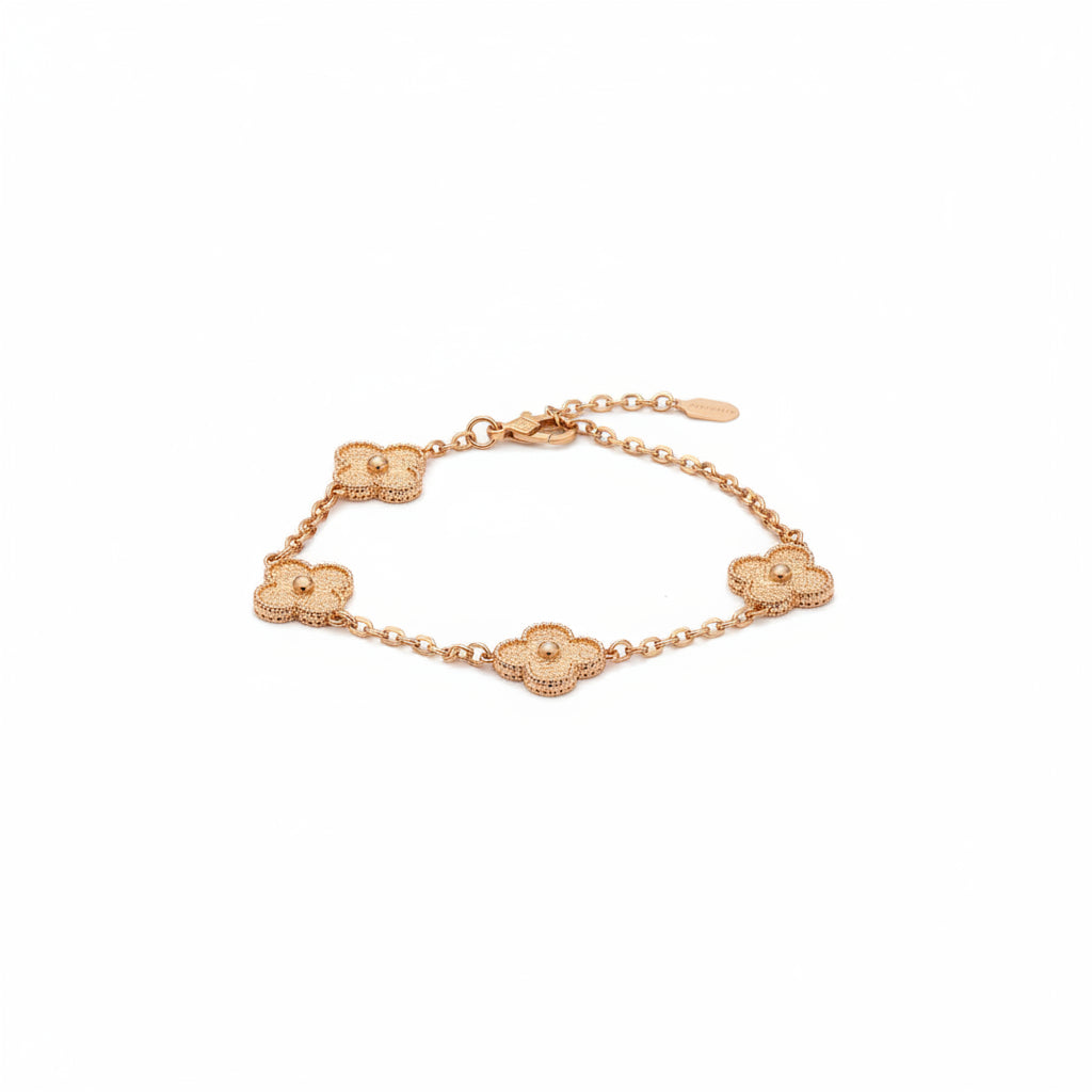 Gold floral bracelet on a speckled 