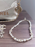 Pearl  and gold necklace with silver clasp.
