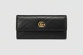 Black quilted wallet with gold logo 