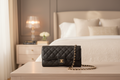 Black quilted handbag with a chain strap 