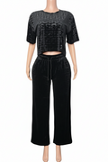 Black outfit with patterned top and wide-leg pants 